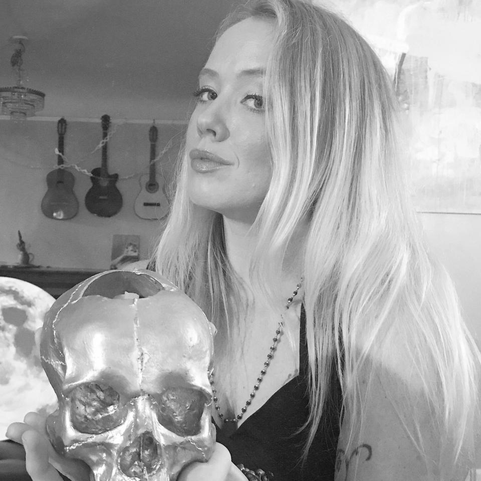 black and white photo of rachael rice, white-skinned woman with blond hair holding a skull black and white photo of rachael rice, white-skinned woman with blond hair holding a skull