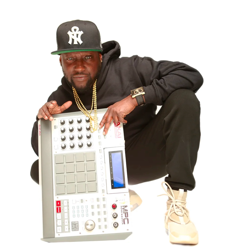 Sol Messiah crouching with MPC sampler on a white background