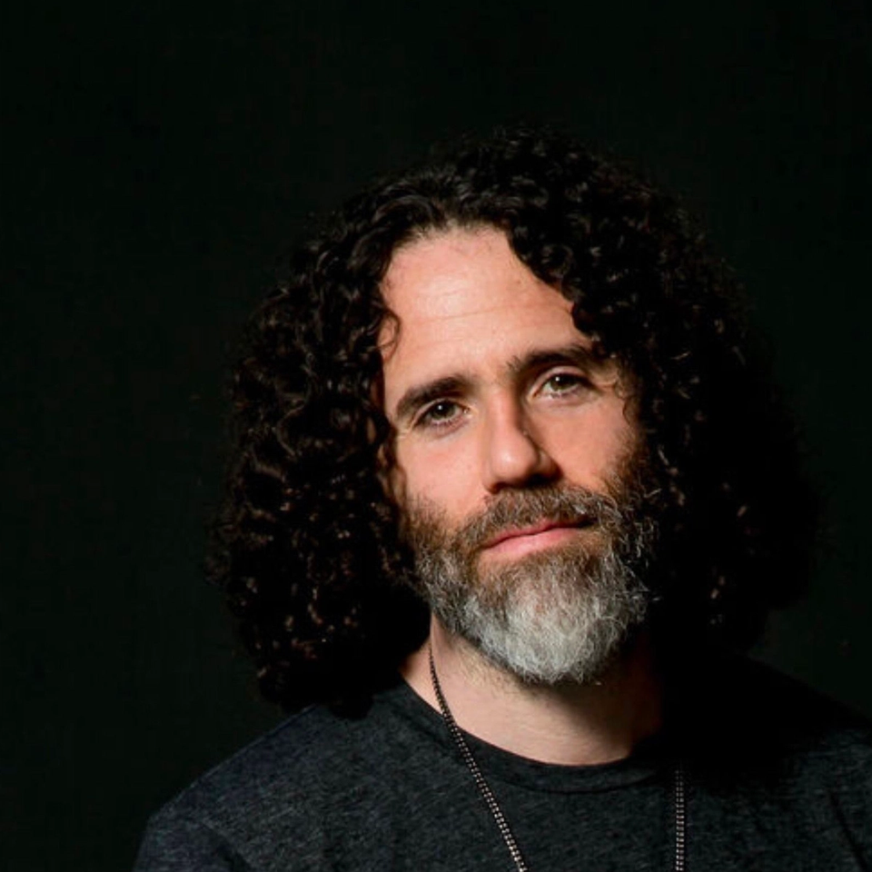 Joshua Penman smiling at the camera on a black background Joshua Penman smiling at the camera on a black background