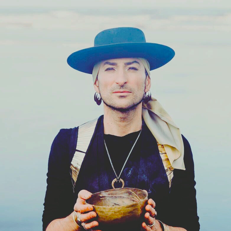 Rafe Pearlman wearing a black hat and holding a gold bowl