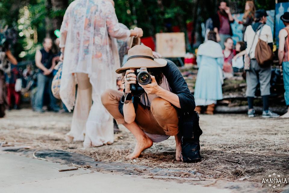 person holding camera kneeling