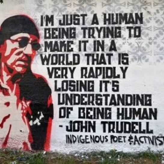 John Trudell quote on a building with painted image John Trudell quote on a building with painted image