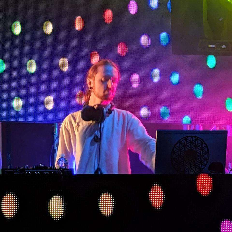 Inner Expression with colorful dots and lights at the computer wearing headphones Inner Expression with colorful dots and lights at the computer wearing headphones