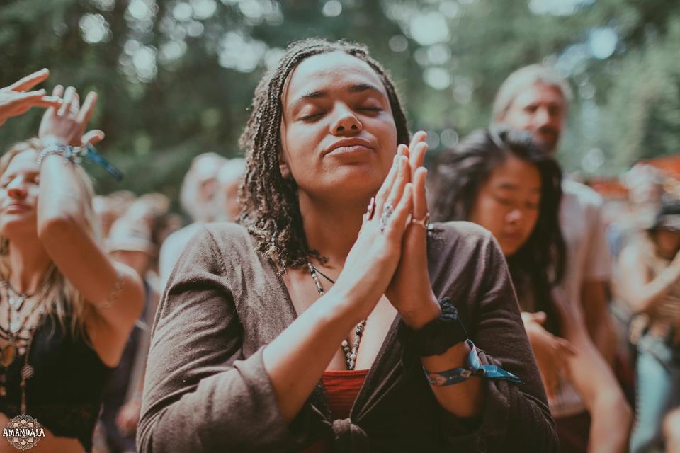 person praying in the audience at Beloved